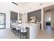 Bright kitchen with barstool seating at the center island and sleek gray cabinets at 8366 E Old Paint Trl # 3, Scottsdale, AZ 85266