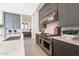 Modern kitchen with stainless steel appliances, gray cabinets, and a marble backsplash at 8366 E Old Paint Trl # 3, Scottsdale, AZ 85266