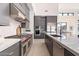 Modern kitchen featuring a wolf oven, stainless steel range hood, and large center island at 8366 E Old Paint Trl # 3, Scottsdale, AZ 85266