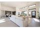 Open concept living room features high ceilings, large windows, neutral furniture, and tiled floors at 8366 E Old Paint Trl # 3, Scottsdale, AZ 85266