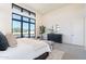 Main bedroom with large window, dresser, decor, and neutral colors at 8366 E Old Paint Trl # 3, Scottsdale, AZ 85266
