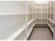 Walk-in pantry features white shelving to ceiling with a neutral-tiled floor at 8366 E Old Paint Trl # 3, Scottsdale, AZ 85266