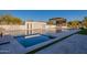 Inviting pool with a tanning ledge, water feature, and adjacent outdoor kitchen at 8366 E Old Paint Trl # 3, Scottsdale, AZ 85266