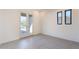 Bright, empty room with tiled floor, patio door and windows revealing the desert landscape at 8366 E Old Paint Trl # 3, Scottsdale, AZ 85266