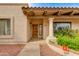 Charming front entrance with decorative column, stucco exterior, and a custom wooden door at 9008 N 83Rd St, Scottsdale, AZ 85258