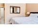 Comfortable bedroom features a king-sized bed and a framed mirror hanging on the wall at 9248 E Blanche Dr, Scottsdale, AZ 85260