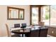 Dining room showcasing a wooden table, seating for six, and a decorative mirror at 9248 E Blanche Dr, Scottsdale, AZ 85260