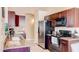Well-lit kitchen featuring stainless steel appliances, granite countertops, and dark wood cabinetry at 9248 E Blanche Dr, Scottsdale, AZ 85260