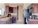 Well-lit kitchen featuring stainless steel appliances, granite countertops, and dark wood cabinetry at 9248 E Blanche Dr, Scottsdale, AZ 85260