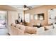Comfortable living room with neutral tones, large sectional, and view to outdoor pool at 9248 E Blanche Dr, Scottsdale, AZ 85260