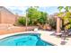 Relaxing outdoor pool area featuring a lounge chair and seating area surrounded by lush greenery at 9248 E Blanche Dr, Scottsdale, AZ 85260
