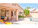 Outdoor pool area featuring a covered patio with ceiling fan and lush landscaping at 9248 E Blanche Dr, Scottsdale, AZ 85260