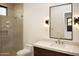 Bathroom with modern vanity, large mirror, and glass-enclosed shower at 9750 E Troon North Dr, Scottsdale, AZ 85262