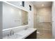 Bathroom features a double sink vanity with illuminated mirror and a walk-in shower at 9750 E Troon North Dr, Scottsdale, AZ 85262