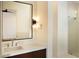 Bathroom featuring a modern vanity, decorative sconces, and a glass-enclosed shower at 9750 E Troon North Dr, Scottsdale, AZ 85262