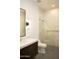 A modern bathroom features a sleek vanity, a large mirror, and a glass-enclosed shower at 9750 E Troon North Dr, Scottsdale, AZ 85262