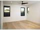 A bright bedroom features wood floors and large windows with views of the surrounding landscape at 9750 E Troon North Dr, Scottsdale, AZ 85262