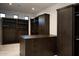 A spacious walk-in closet featuring custom dark wood shelving and drawers at 9750 E Troon North Dr, Scottsdale, AZ 85262