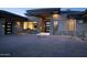 Contemporary home showcasing a brick driveway, stone accents, and modern multi-paneled front door at 9750 E Troon North Dr, Scottsdale, AZ 85262