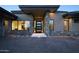 Modern home featuring a textured brick driveway leading to a gray stone and stucco facade at 9750 E Troon North Dr, Scottsdale, AZ 85262