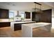 Spacious modern kitchen with double islands, dark wood cabinets, and stainless steel appliances at 9750 E Troon North Dr, Scottsdale, AZ 85262