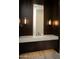 Modern powder room with elegant dark wood vanity, quartz countertop, and stylish sconces at 9750 E Troon North Dr, Scottsdale, AZ 85262