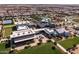 Expansive aerial view showcasing the community buildings and amenities, including a pool and common areas at 10127 E Tillman Ave, Mesa, AZ 85212