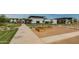 Landscaped community park with walking paths, green spaces, and a glimpse of the neighborhood pool and recreation at 10127 E Tillman Ave, Mesa, AZ 85212
