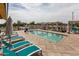 Relaxing community pool with comfortable lounge chairs and shaded cabanas, perfect for enjoying the outdoors at 10127 E Tillman Ave, Mesa, AZ 85212