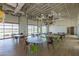 Versatile community room with multiple tables, chairs, and garage door-style windows for open views at 10127 E Tillman Ave, Mesa, AZ 85212