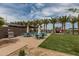 Outdoor grill and dining area next to the community center, complete with shade and nearby palm trees at 10127 E Tillman Ave, Mesa, AZ 85212