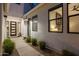 A modern entryway featuring a stylish door, decorative lighting, and sleek landscaping for a welcoming ambiance at 10127 E Tillman Ave, Mesa, AZ 85212