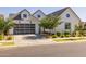 Contemporary home featuring a gray garage door, manicured lawn, and tastefully landscaped front yard at 10127 E Tillman Ave, Mesa, AZ 85212