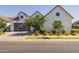 Charming home featuring modern architectural design, a two-car garage, manicured landscaping, and inviting outdoor lighting at 10127 E Tillman Ave, Mesa, AZ 85212
