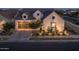 Charming home featuring modern architectural design, a two-car garage, manicured landscaping, and inviting outdoor lighting at 10127 E Tillman Ave, Mesa, AZ 85212