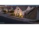 Inviting home with a well-maintained yard, complemented by exterior lighting and charming architectural details at 10127 E Tillman Ave, Mesa, AZ 85212