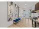 Bright foyer with wood-style flooring, modern artwork, and a blue velvet bench at 10127 E Tillman Ave, Mesa, AZ 85212
