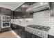 Modern kitchen features stainless steel KitchenAid appliances, white subway tile backsplash, and dark cabinetry at 10127 E Tillman Ave, Mesa, AZ 85212