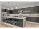 Modern kitchen with stainless steel appliances, a large island, and elegant pendant lighting at 10127 E Tillman Ave, Mesa, AZ 85212