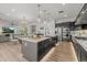 Island kitchen featuring modern appliances, a stylish sink, pendant lighting, and an open view to the living and dining area at 10127 E Tillman Ave, Mesa, AZ 85212