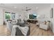 Comfortable living room featuring stylish furniture, a modern ceiling fan, and large windows for ample light at 10127 E Tillman Ave, Mesa, AZ 85212