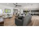 An open-concept space with wood floors, contemporary furniture, and seamless flow to the dining and kitchen areas at 10127 E Tillman Ave, Mesa, AZ 85212