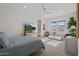 Bright main bedroom with a ceiling fan, large windows, and a television at 10127 E Tillman Ave, Mesa, AZ 85212