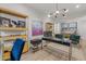 Bright home office with modern furnishings, natural light, and stylish decor and shelving at 10127 E Tillman Ave, Mesa, AZ 85212