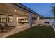 Covered outdoor patio with kitchen access and a modern fireplace, perfect for entertaining at 10127 E Tillman Ave, Mesa, AZ 85212