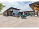 Large outdoor patio featuring dining tables, lounge areas, and a modern building exterior at 10127 E Tillman Ave, Mesa, AZ 85212