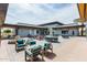 Inviting outdoor patio with comfortable seating, dining areas, and a serene fountain at 10127 E Tillman Ave, Mesa, AZ 85212