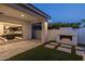 Inviting outdoor patio with a modern fireplace and easy access to an indoor kitchen at 10127 E Tillman Ave, Mesa, AZ 85212