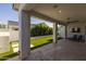 Covered patio with travertine tile flooring and outdoor seating area for entertaining guests at 10127 E Tillman Ave, Mesa, AZ 85212