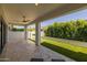 Extended covered patio with travertine tile flooring and artificial turf at 10127 E Tillman Ave, Mesa, AZ 85212